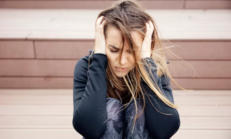 angry-sad-young-woman-sitting-outdoor_11zon